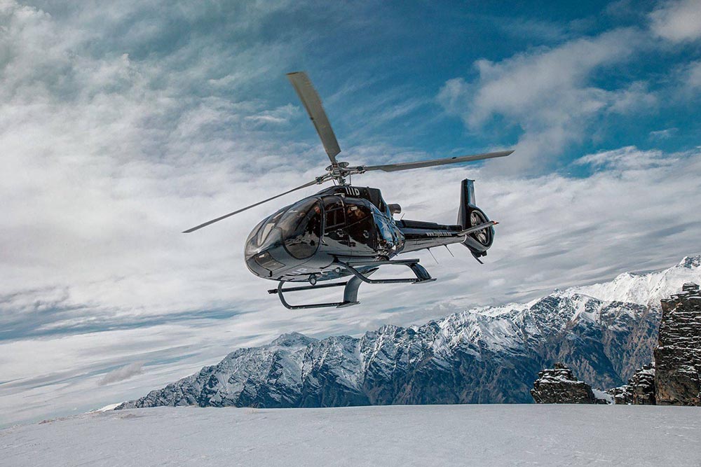 Eurocopter EC130 and snow capped mountains