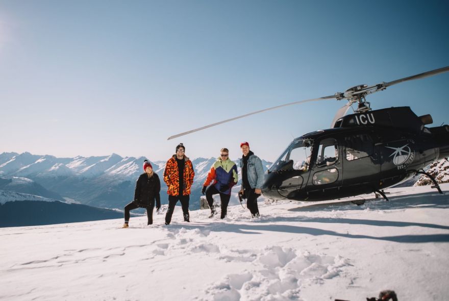 Group Enjoying the Alpine Snow Helicopter Landing